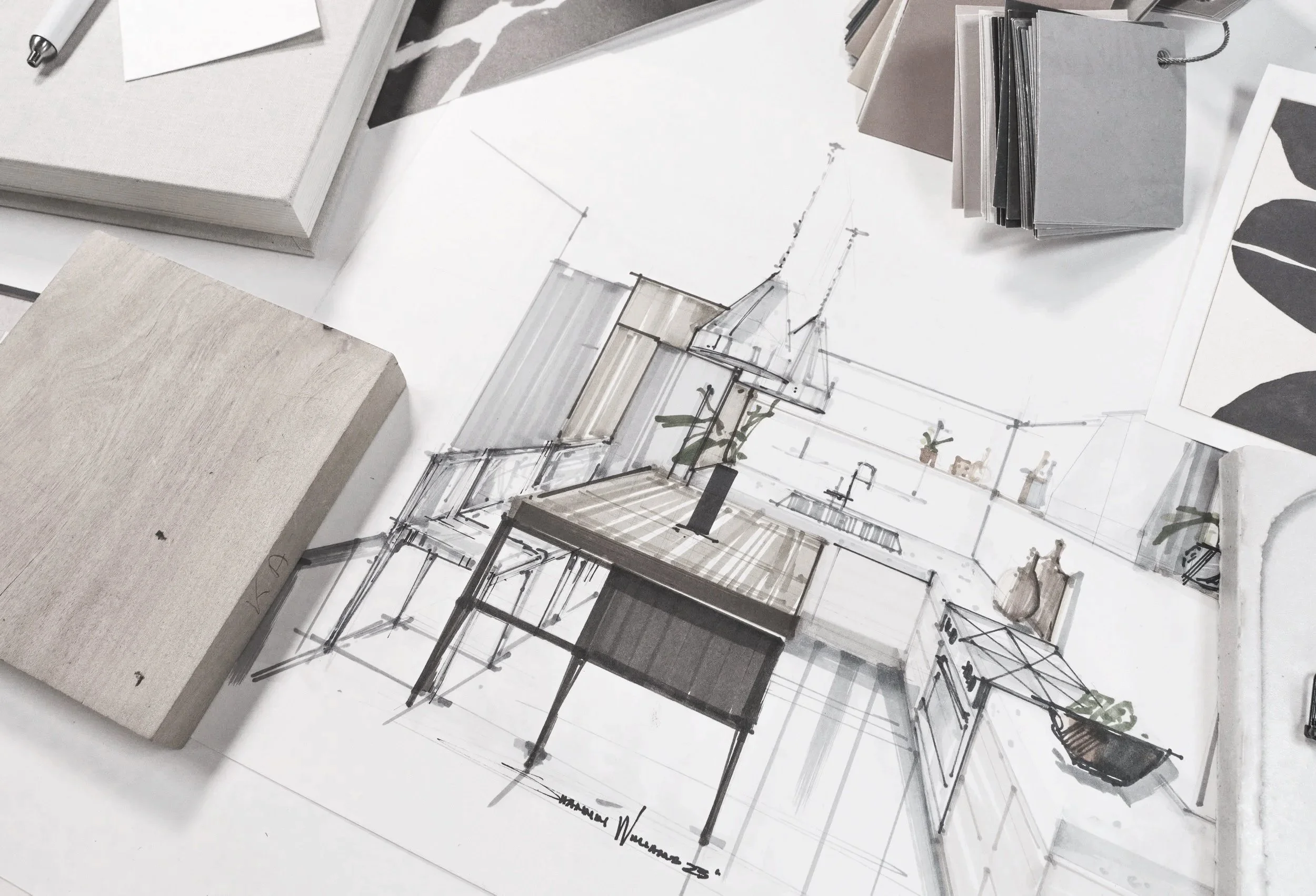 Architectural sketch of a modern kitchen with a central island, plants, and cabinetry, surrounded by samples of fabric, color swatches, and design materials.