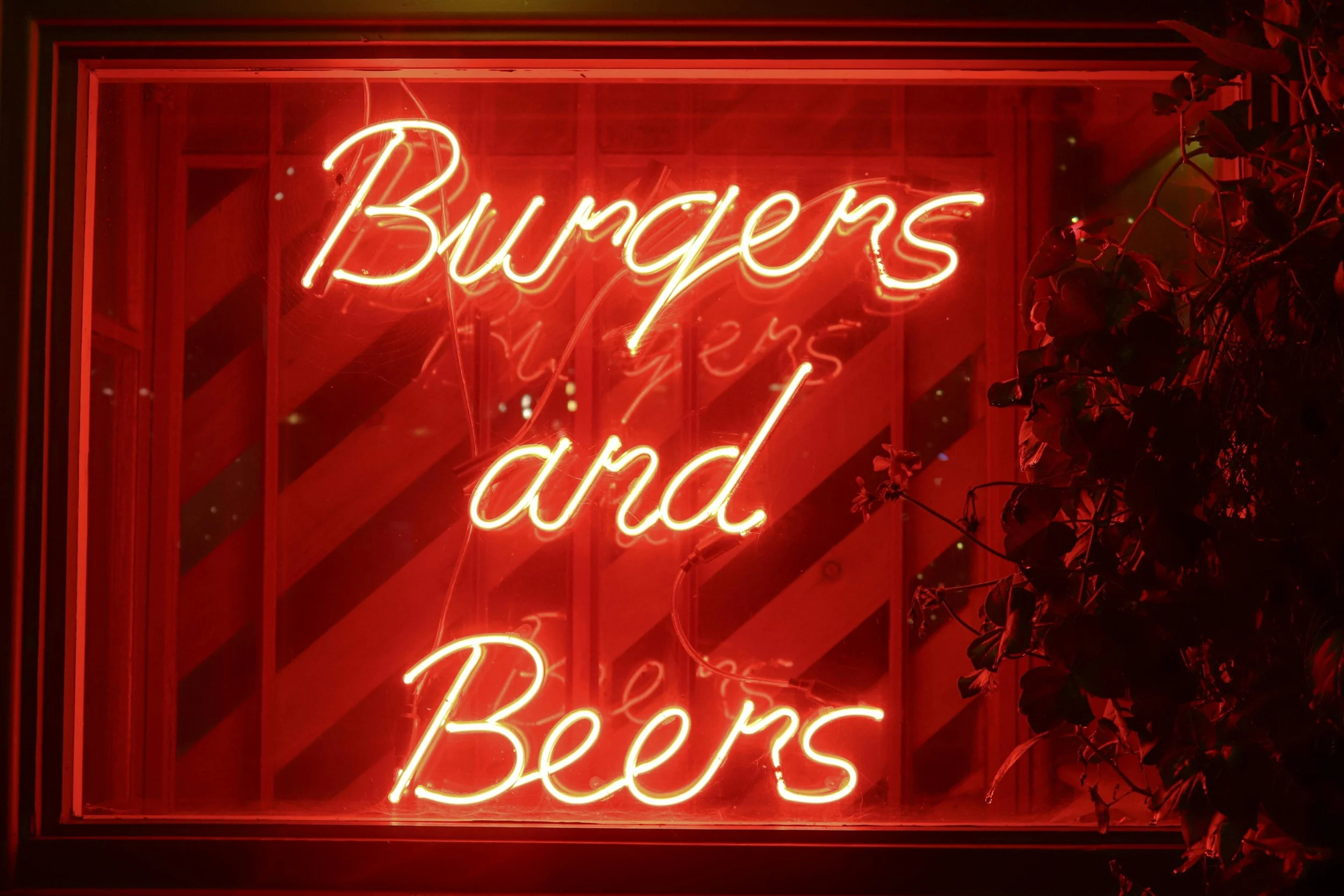 Neon “Burgers and Beers” restaurant sign representing casual dining and hospitality branding.