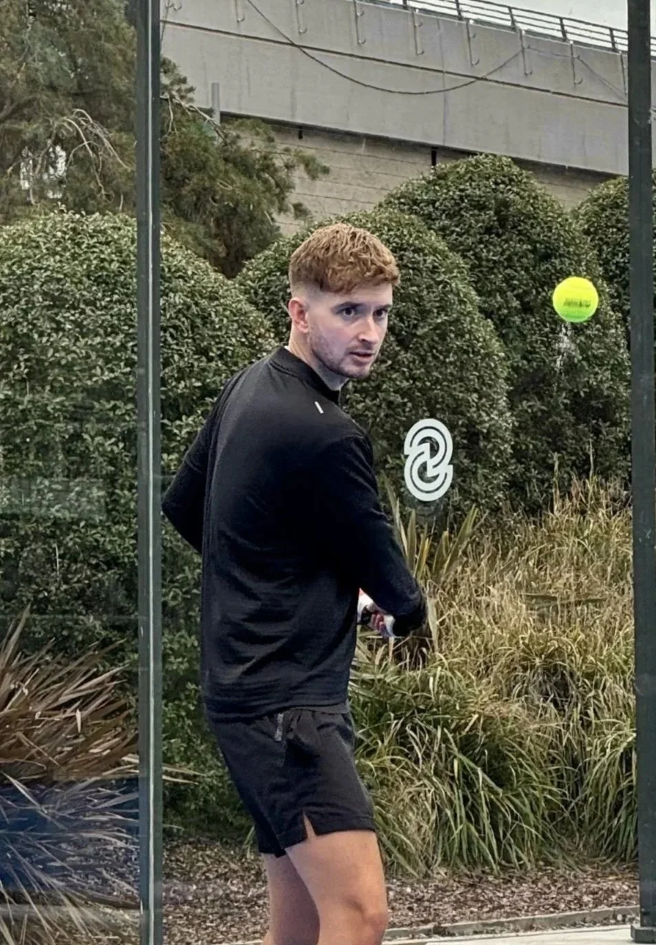 A white spherical object casting a shadow on a plain white surface.