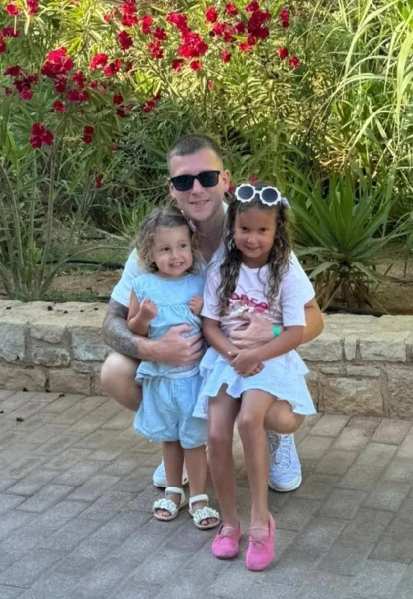 A white egg casting a shadow on a light gray surface.