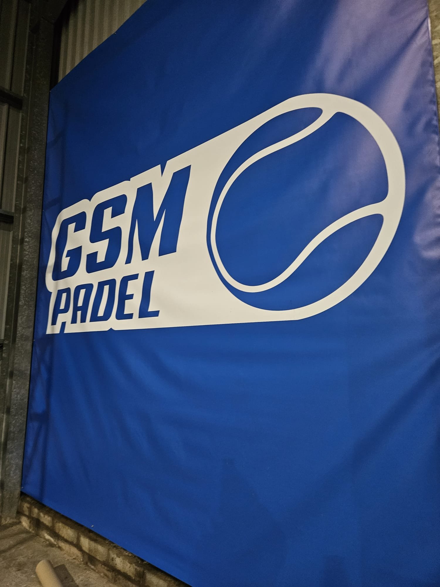 Blue banner with white text and logo reading 'GSM Padel' and a stylized padel ball image.