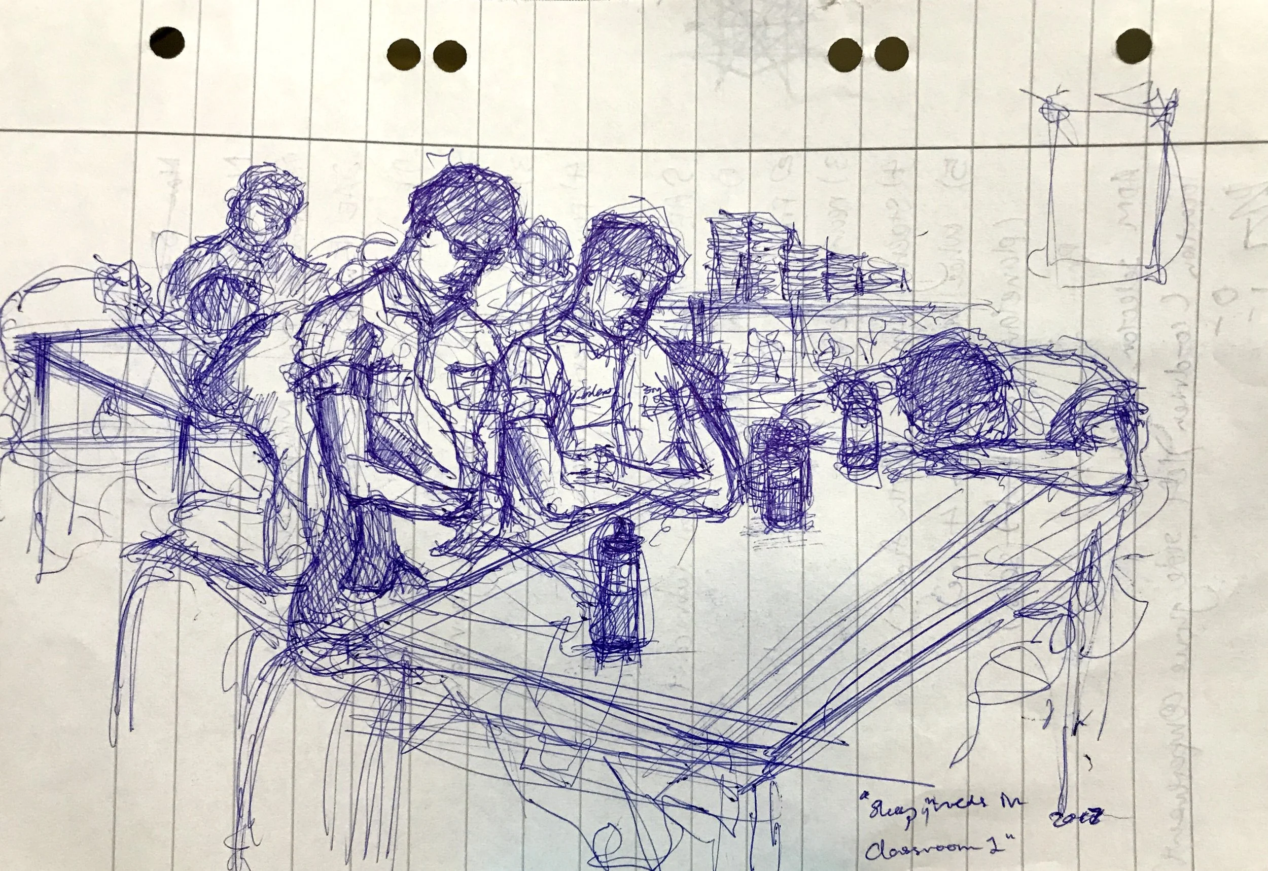 A detailed blue ink sketch of five people sitting around a table and one lying on the table as if asleep, in a classroom setting with books and a felt-tip pen on the table, and a bulletin board or wall in the background.