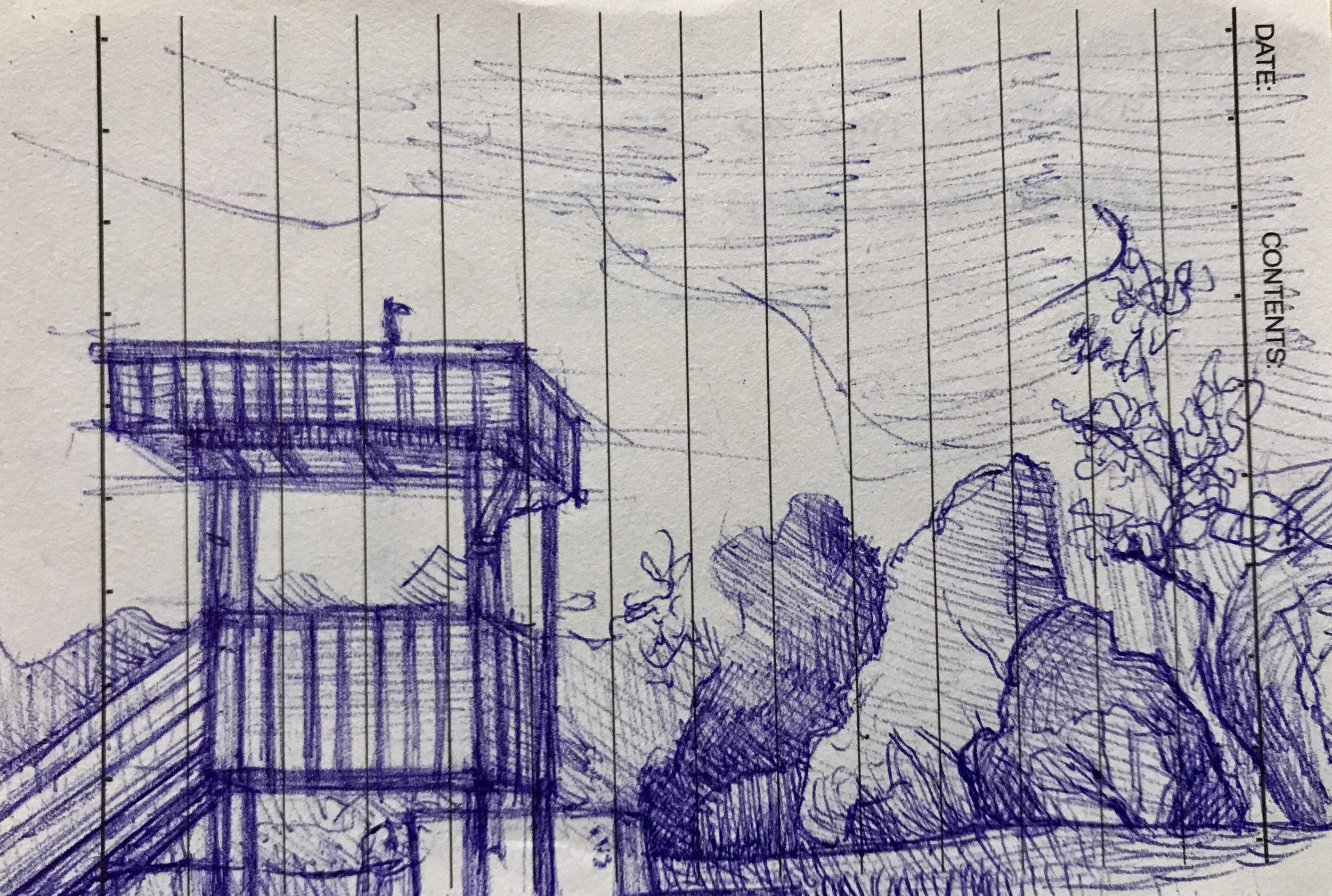 A detailed, hand-drawn sketch made with a blue ink pen on lined notebook paper, depicting a wooden observation tower among trees with mountains and cloudy sky in the background.