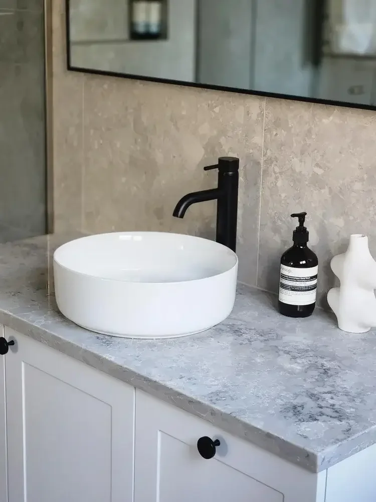 Modern bathroom renovation with stone vanity, vessel basin and black tapware in Albury