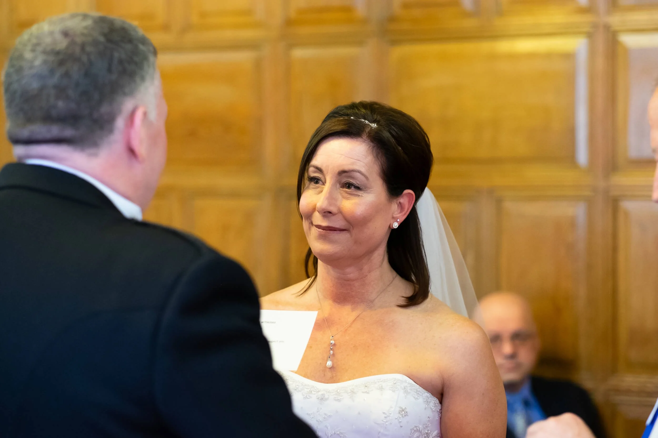 Bride looking at groom during wedding vows at Edinburgh Castle — documentary wedding photography Scotland
