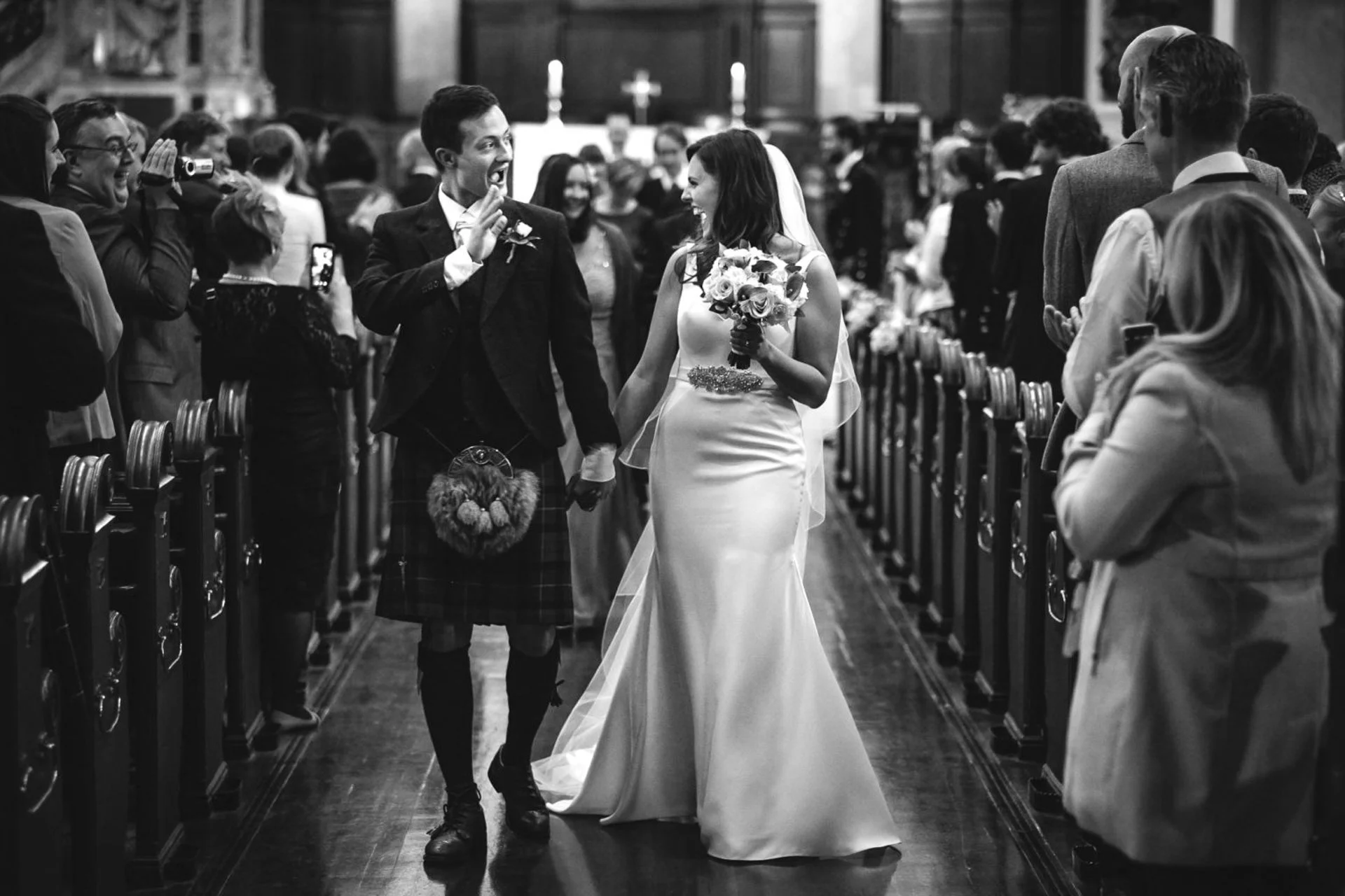 Bride and groom leaving ceremony at St Cuthbert's Parish Church Edinburgh — documentary wedding photography Scotland