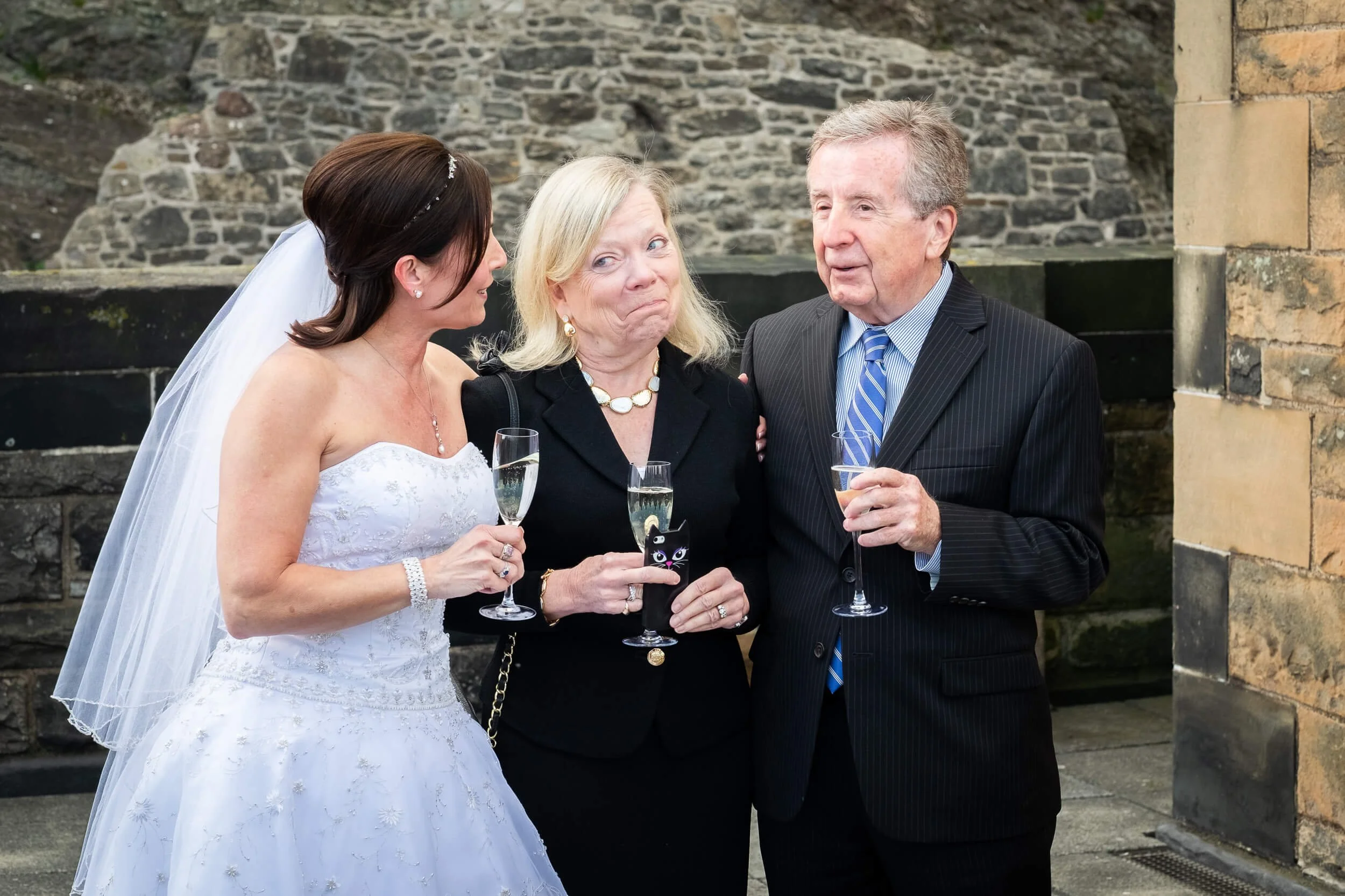 Bride with family guests celebrating after wedding ceremony at Edinburgh Castle — candid documentary wedding photography Scotland