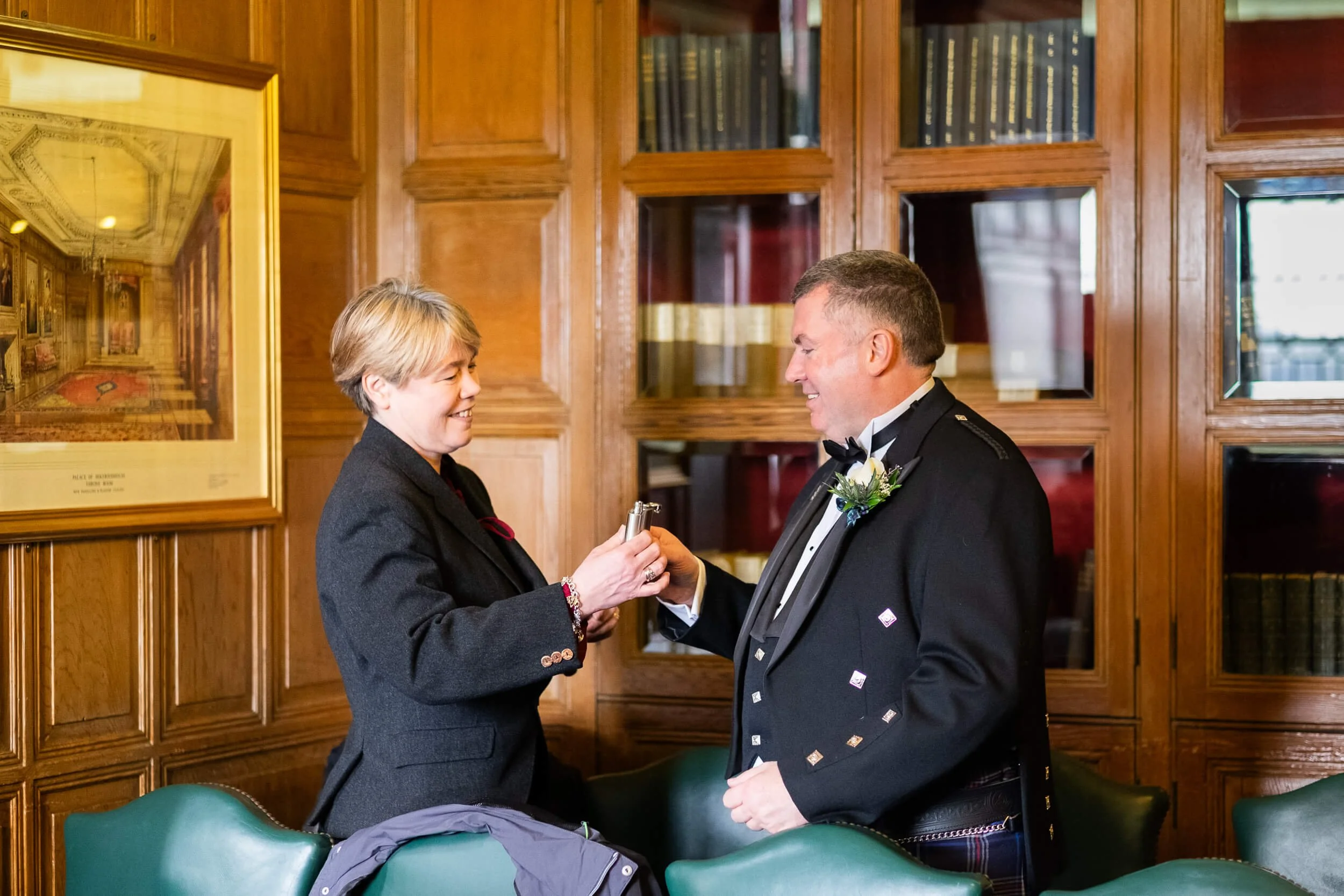 Groom in Scottish kilt sharing a moment with a guest before the wedding ceremony at Edinburgh Castle