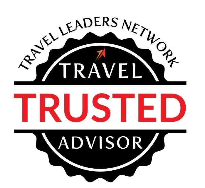 Badge with the words "Travel Trusted" and "Travel Leaders Network" in a circular design, featuring a small red arrow pointing upward.