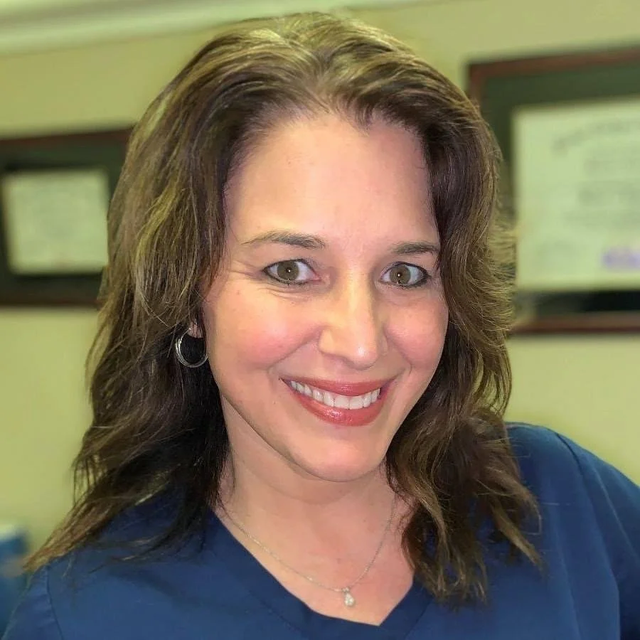 Dr. Madeline C. Johnston, Addison Chiropractic in blue scrubs