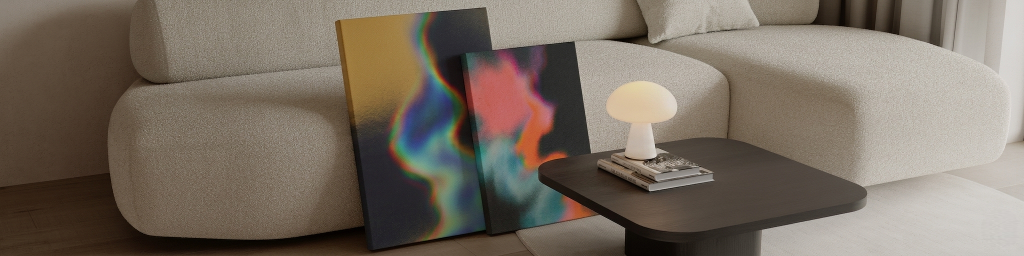 Two abstract colorful paintings leaning against a beige sofa in a living room.