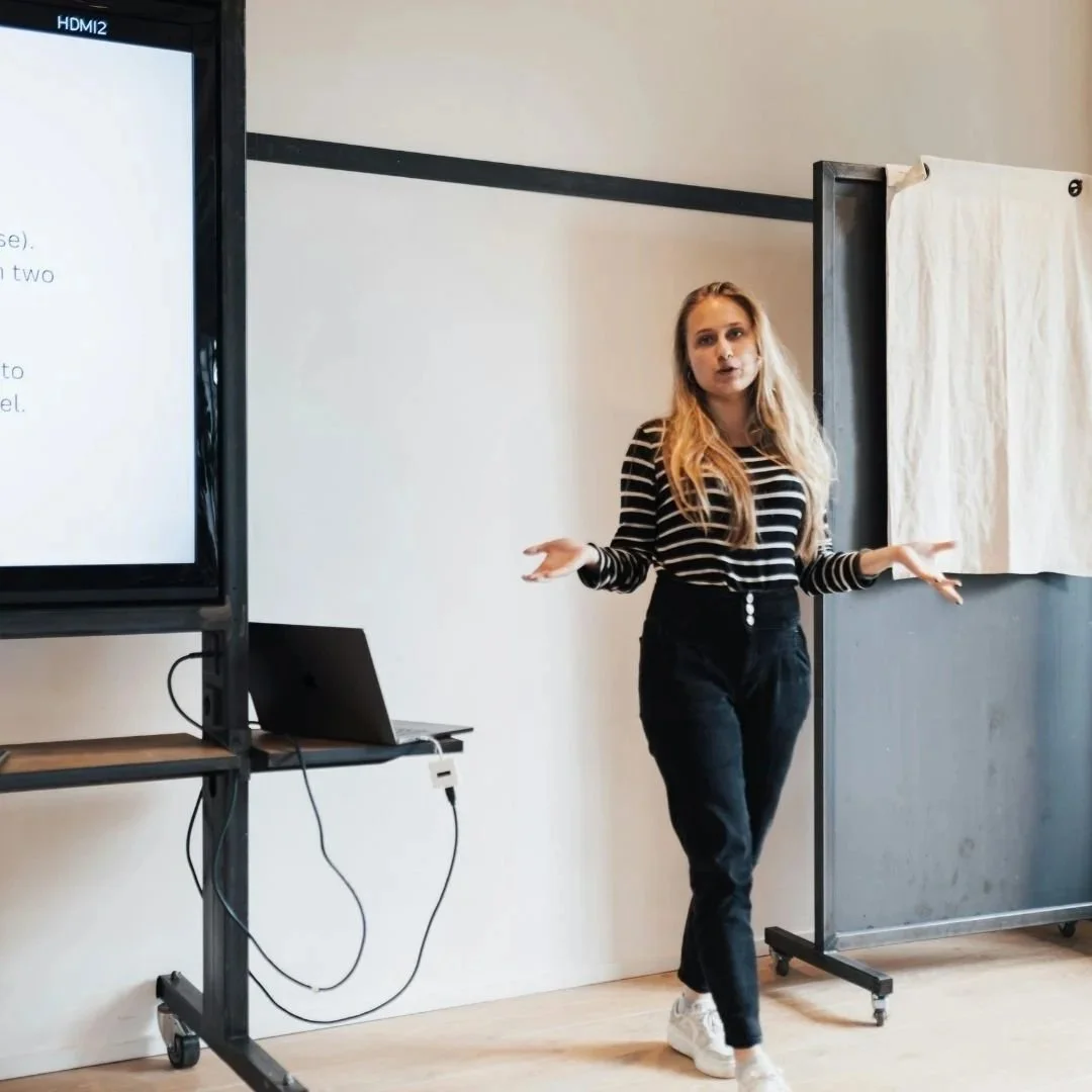a woman confidently giving a presentation