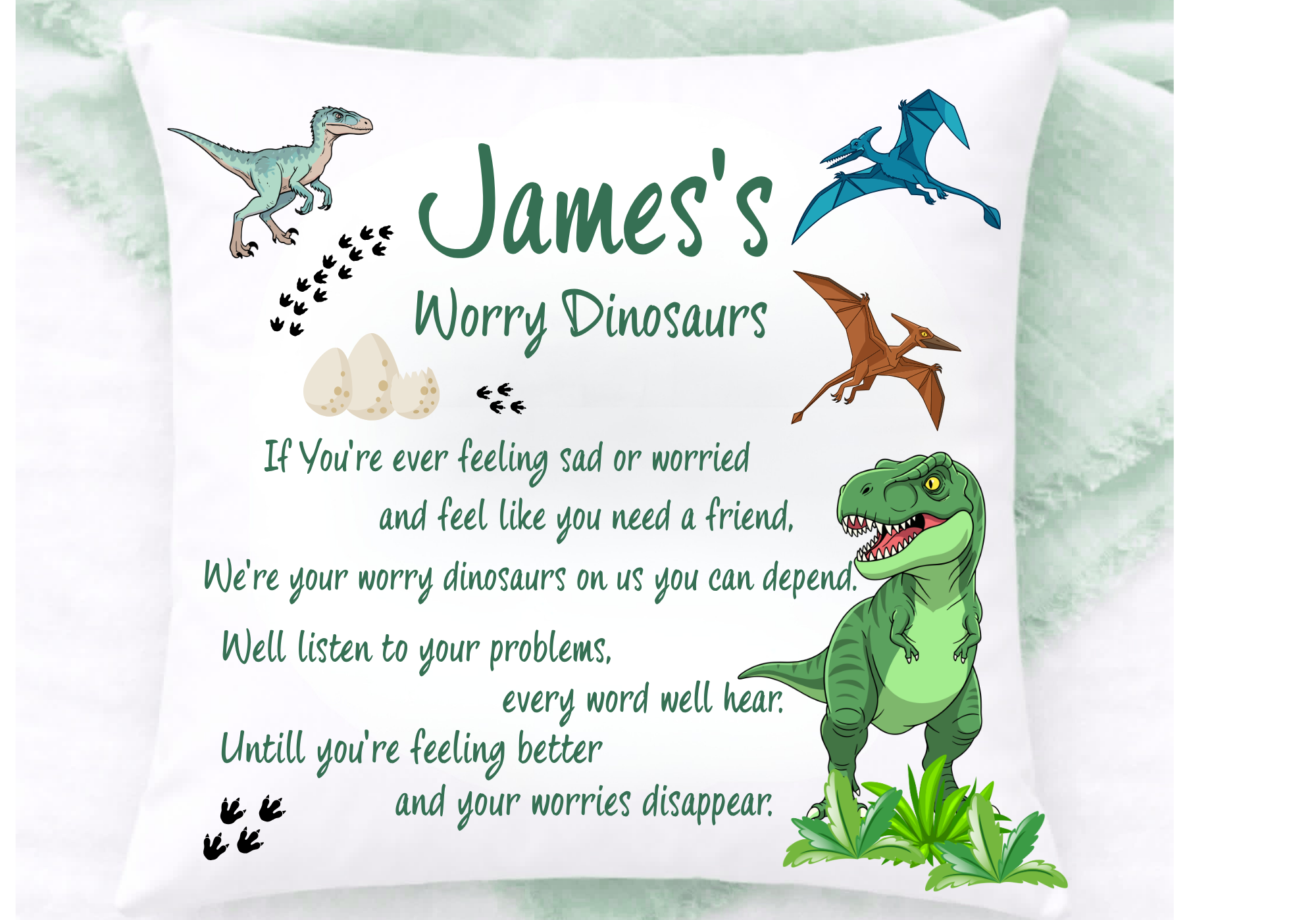 A decorative pillow with cartoon illustrations of dinosaurs, including a T-Rex and a Pterodactyl, and dinosaur eggs. The pillow has a message about feeling better and worrying less.