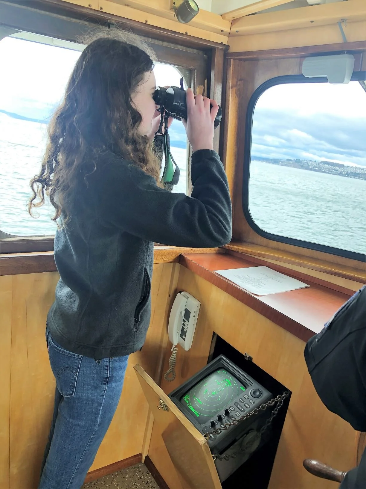 SAMI student Maddy conducts log watch to make sure the waters are safe and clear while her classmates on deck conduct their experiments.