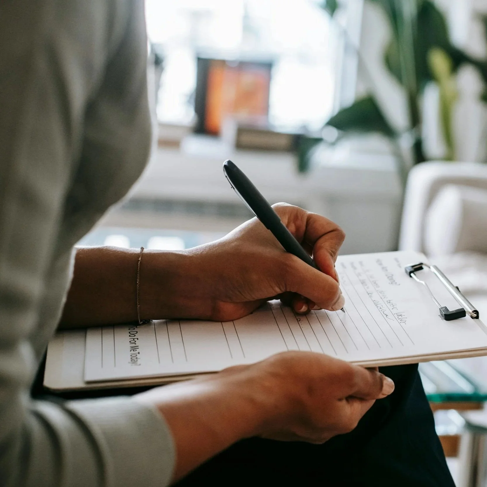 ear nose and throat patient completing appointment form in ENT doctors waiting room