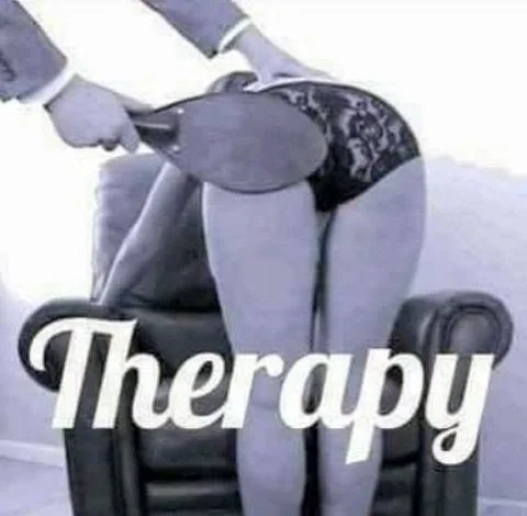 Person standing on a chair, holding a paddle behind their back, with the word "Therapy" overlaid at the bottom.