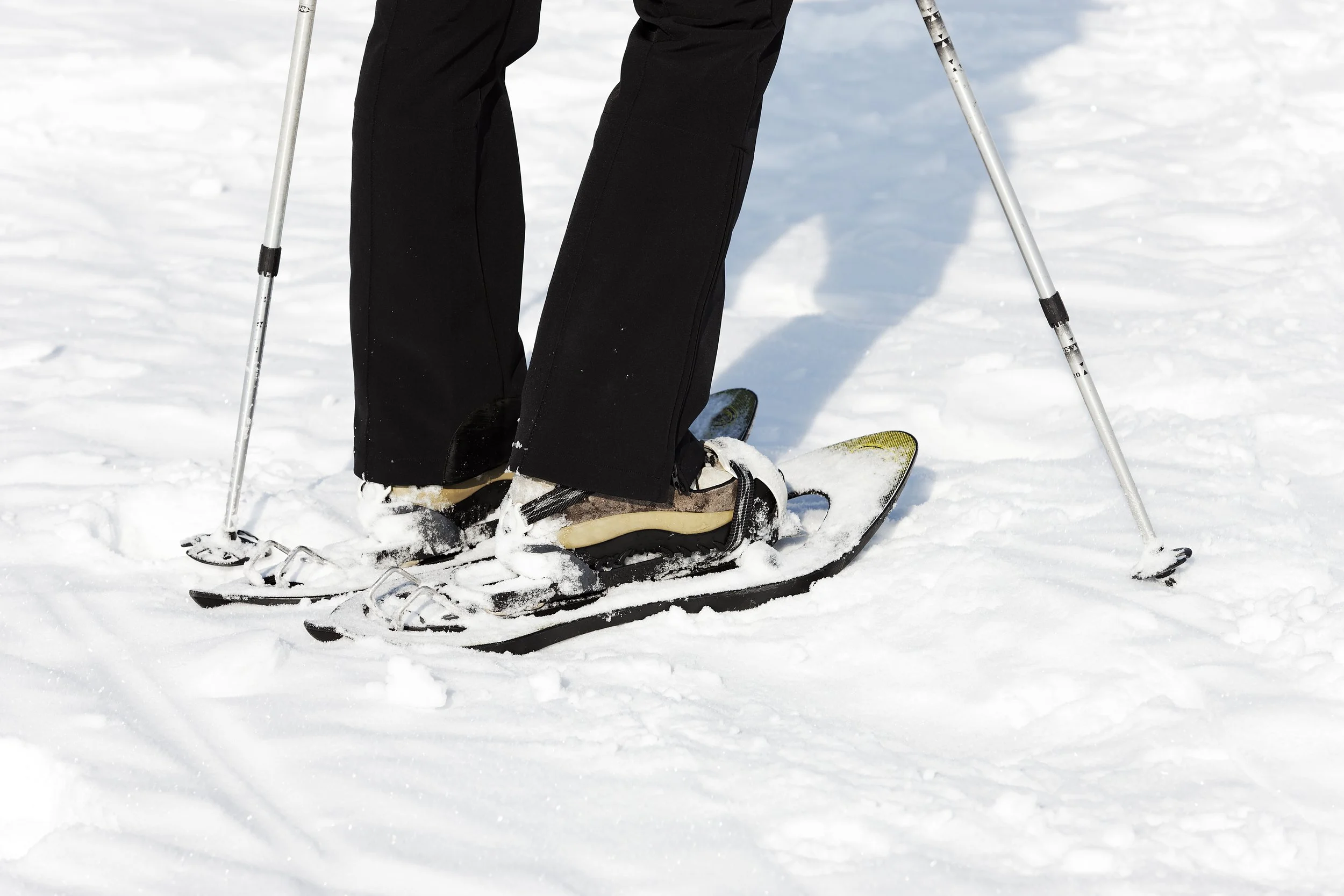 woman-walking-snow-with-rackets.jpg
