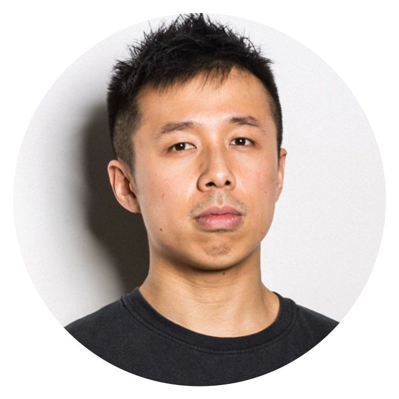 Portrait of a young Asian man with short black hair, wearing a black T-shirt, looking directly at the camera with a neutral expression.