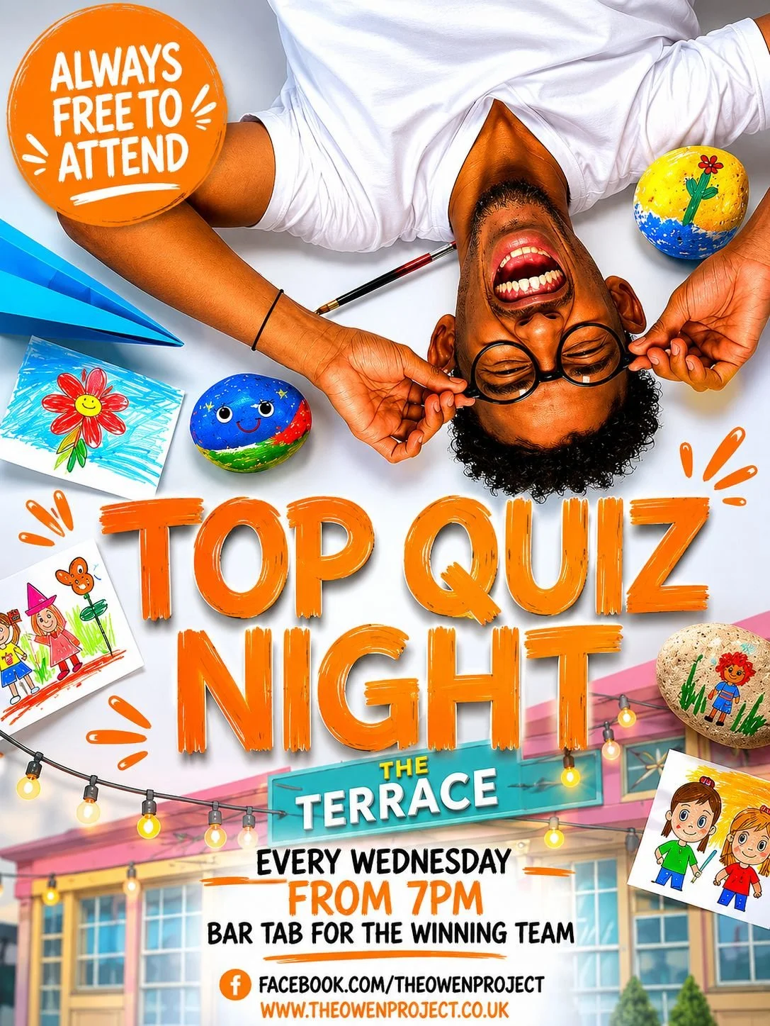 A joyful man with glasses lying upside down on a table surrounded by colorful painted rocks and drawings, promoting a weekly quiz night at a venue.