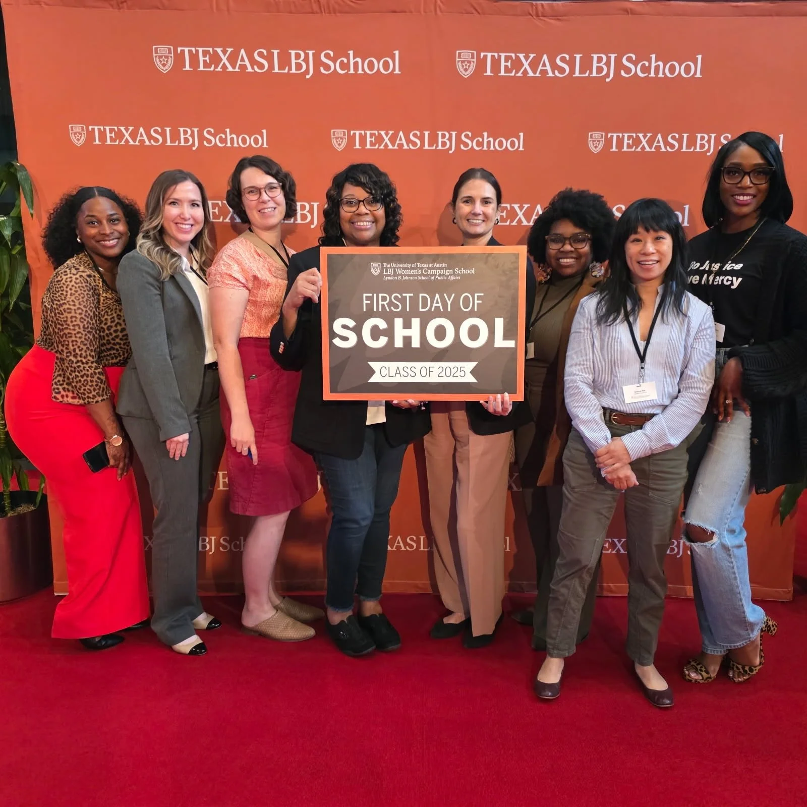 Group of women standing together on red carpet at the first day of school event, holding a sign that reads 'First Day of School, Class of 2025', with a backdrop featuring 'TEXAS LBJ School' branding.