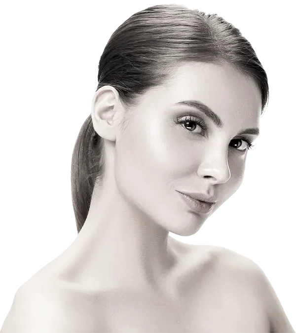 A close-up, black-and-white portrait of a woman with her hair pulled back, looking slightly to the side with a subtle smile.