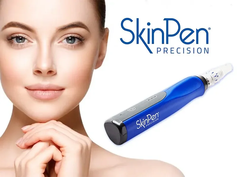 A woman with clear skin smiling and touching her chin, alongside a blue SkinPen Precision device.