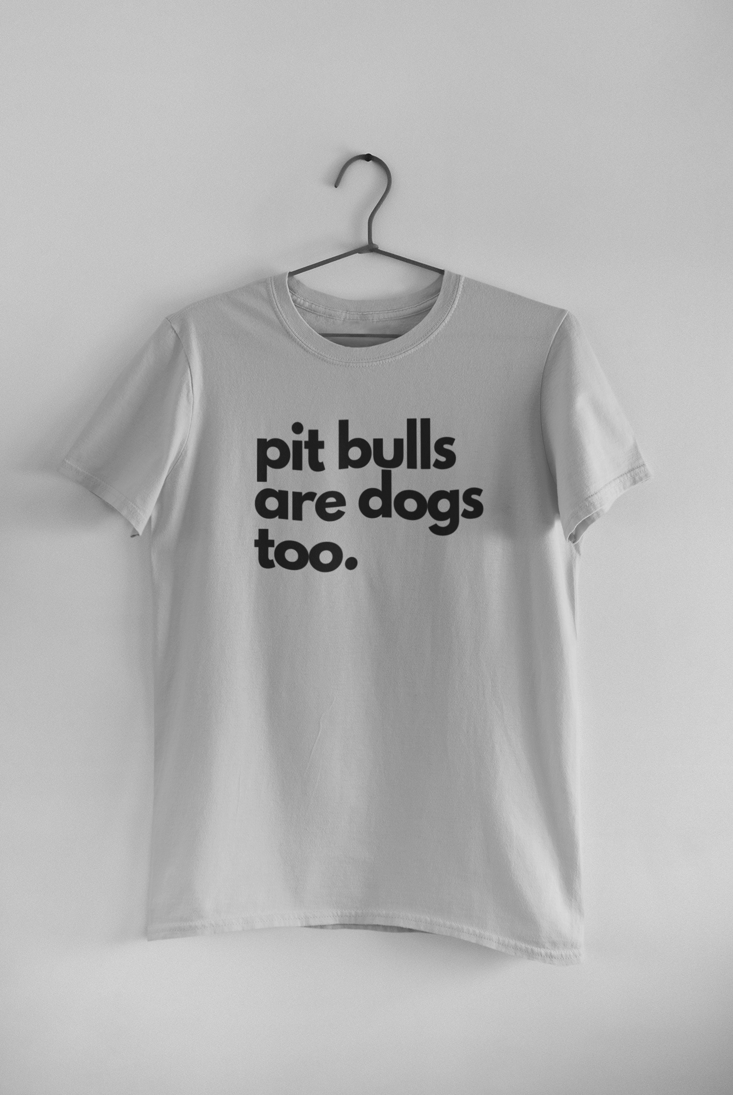 gray t-shirt featuring bold black typography reading "Pit Bulls Are Dogs Too." A minimalist pit bull advocacy design promoting education, compassion, and breed awareness.