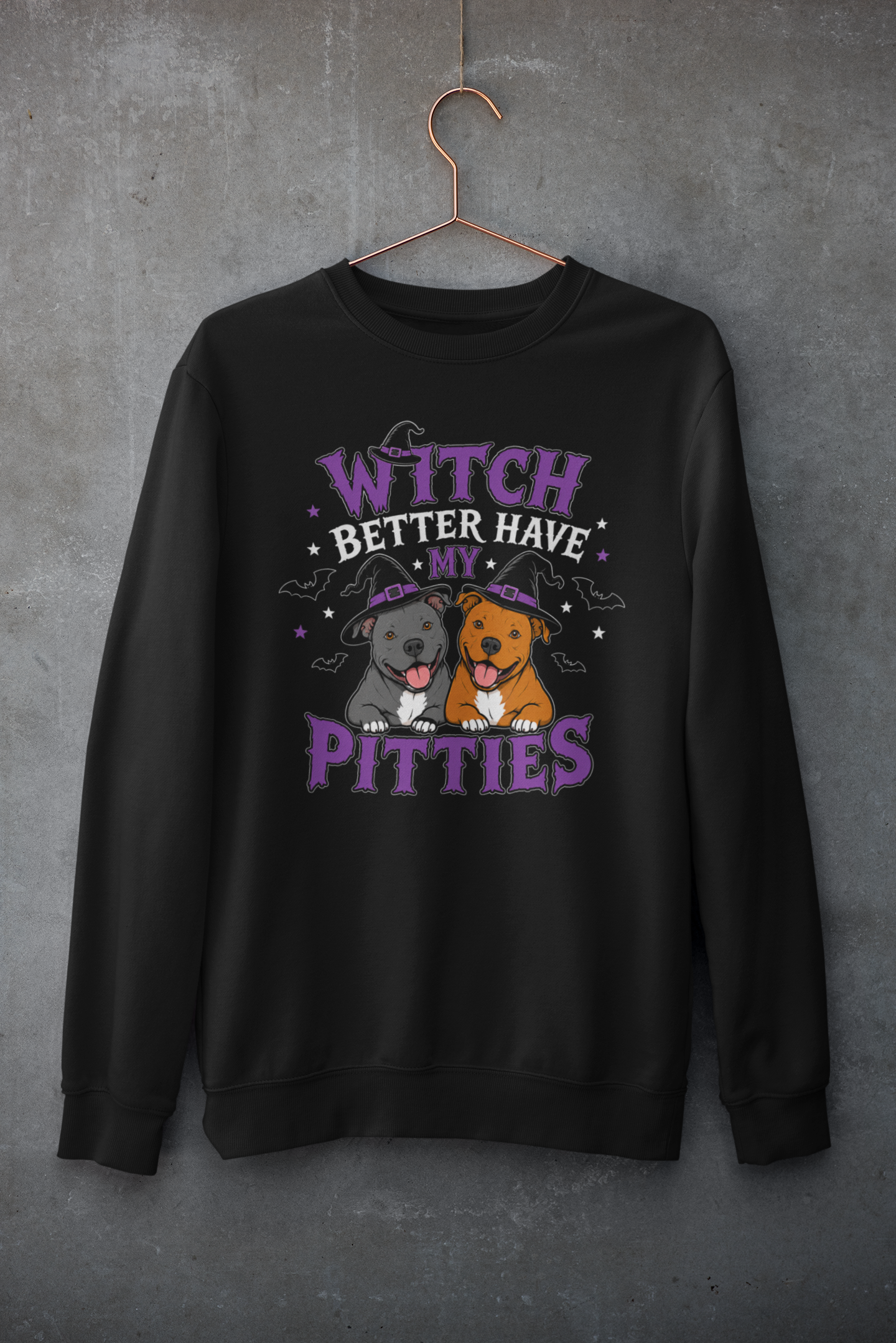 Black Halloween crewneck featuring two smiling pit bulls wearing witch hats with purple and black typography reading “Witch Better Have My Pitties,” surrounded by bats and stars.