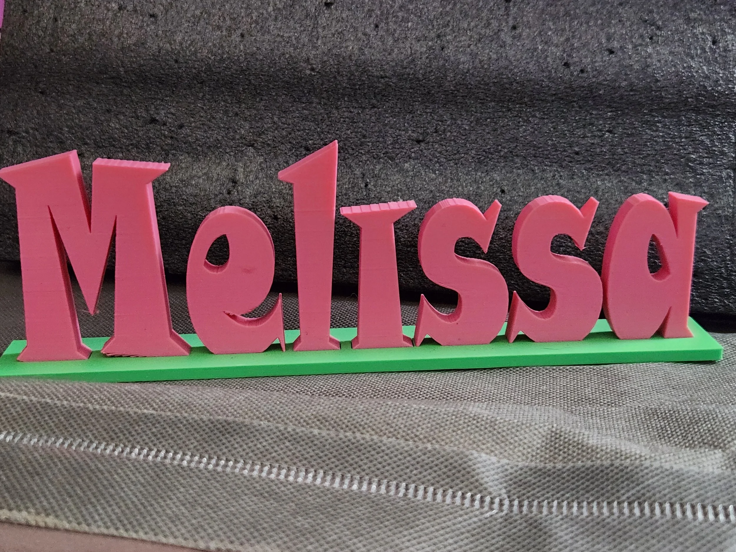 Pink decorative sign spelling 'MOM