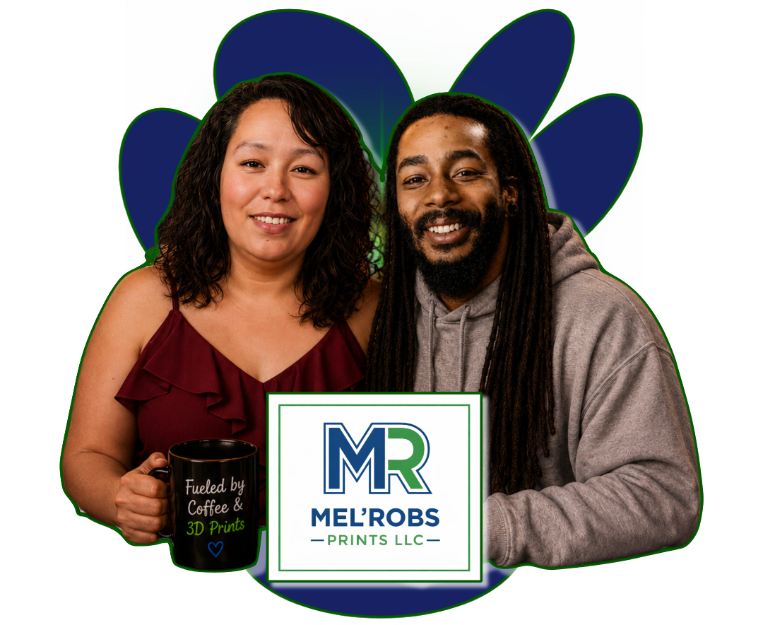 A man with dreadlocks and a woman with curly hair holding a coffee mug, standing in front of a spade-shaped background and a sign that reads 'Mel Ro Bs Prints LLC.'
