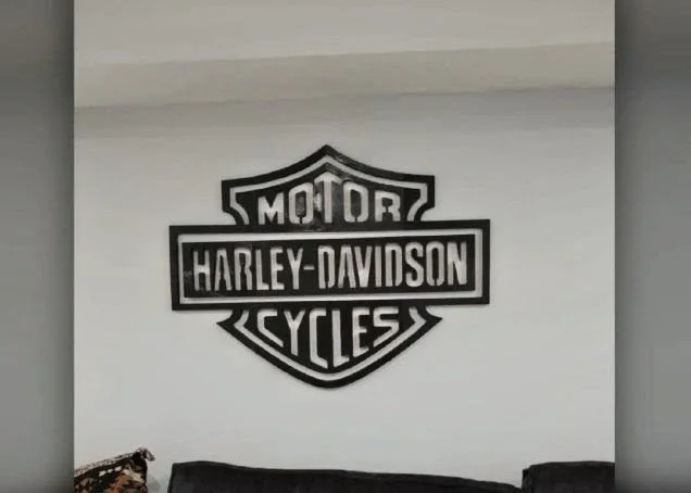 Harley-Davidson logo on a white wall.