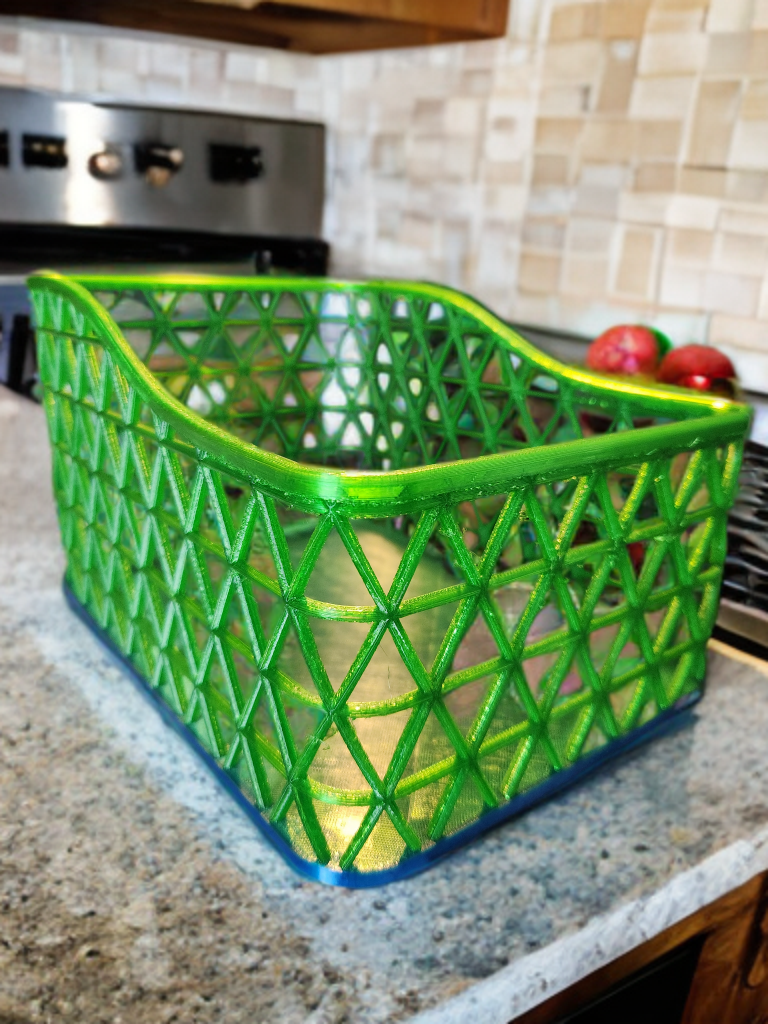Green plastic basket with a lattice design on kitchen counter.