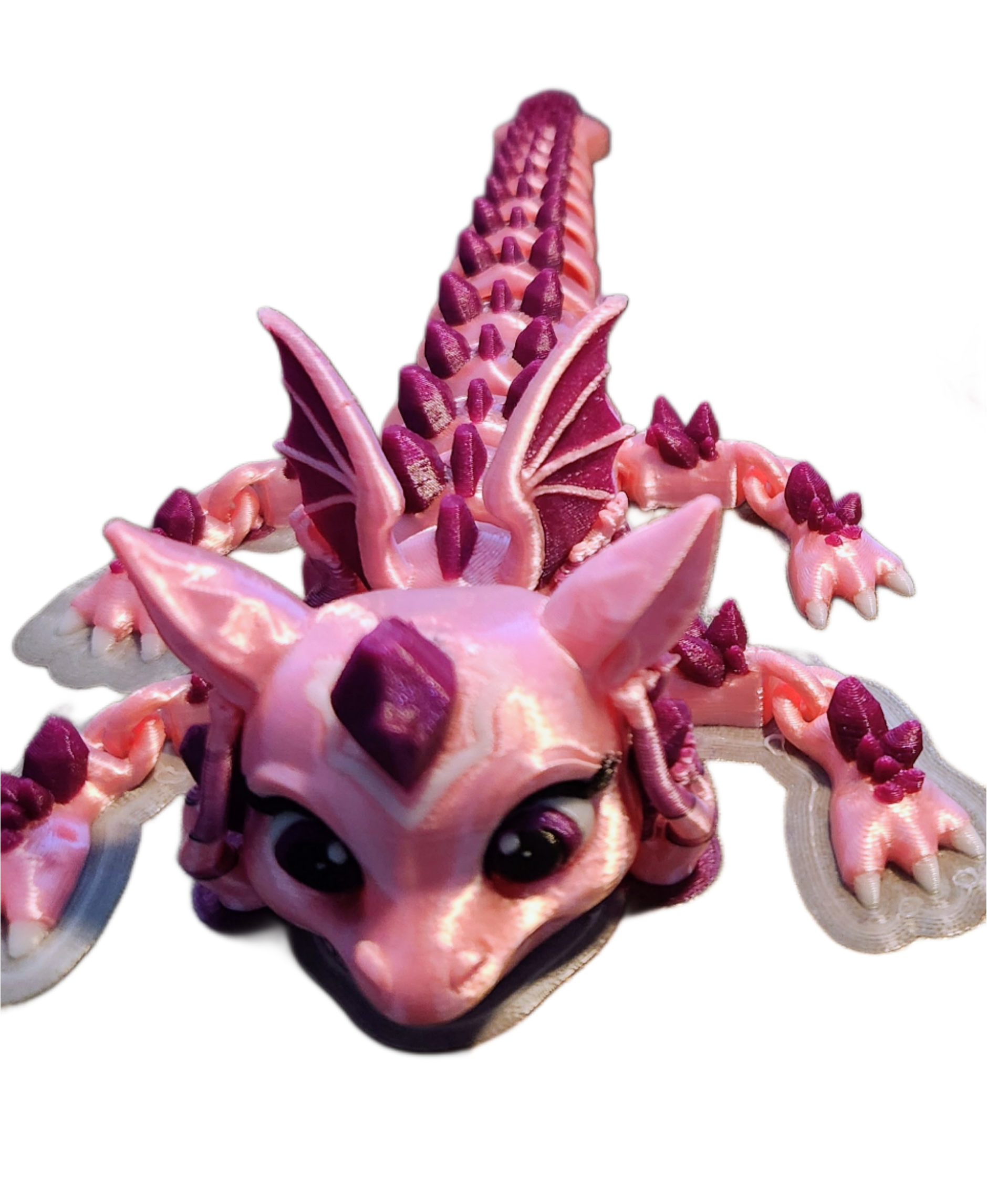 Close-up of a pink and purple starfish with a small fish inside its mouth, black background.