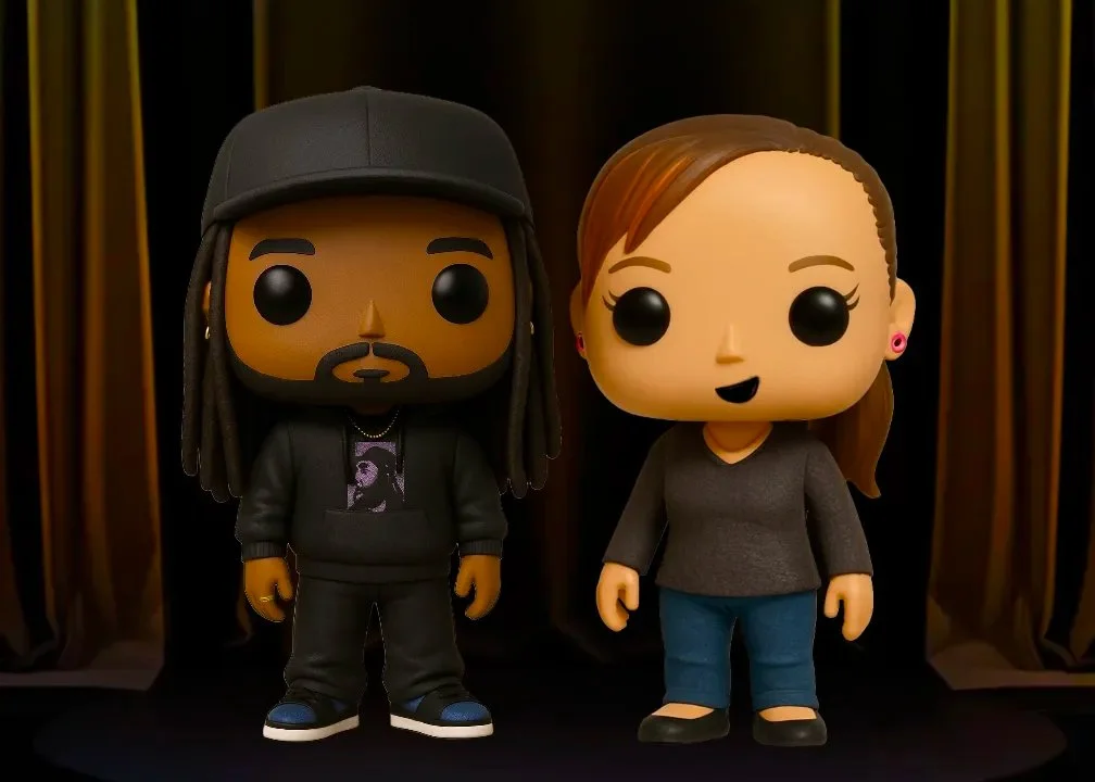 Two Funko Pop! figures, a male with dreadlocks, a beard, wearing a black cap, black hoodie, black pants, and sneakers, and a female with long brown hair, wearing a dark gray top, blue jeans, and black shoes, standing in front of a gold and black patterned background.