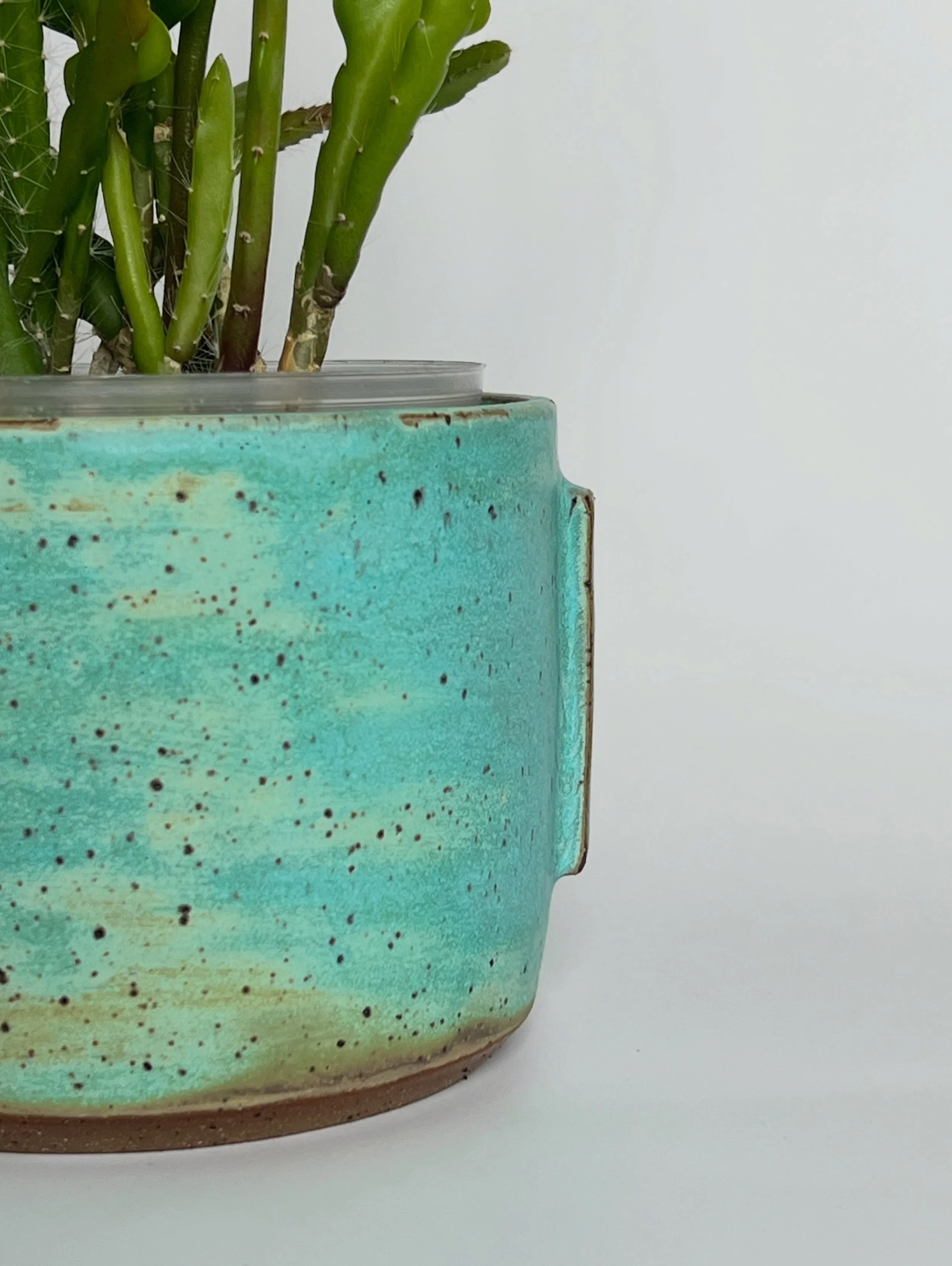 Some pieces start with a clear vision. These two started with a question: what happens if I apply a simple rectangular tab to a thrown form and let the glaze do the rest?

The answer, it turns out, is this. The Weathered Bronze glaze &mdash; develope