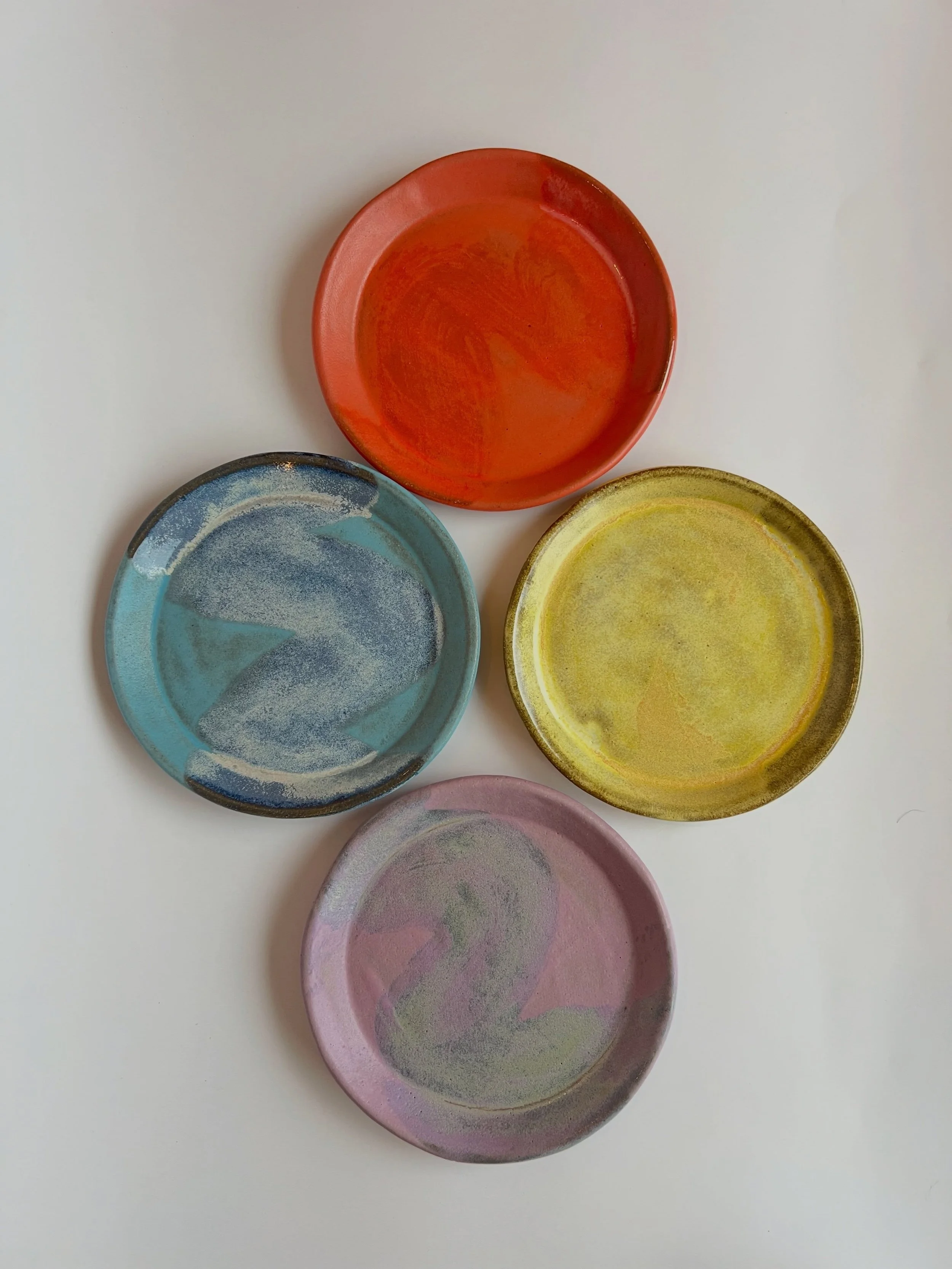 Three new plate sets, three small worlds. 🍰

Each one was slab-built by hand from local stoneware and finished in layered glazes. One set is brushed, one is dotted, and one is drawn. They're sized for dessert, a cheese course, the last slice nobody 