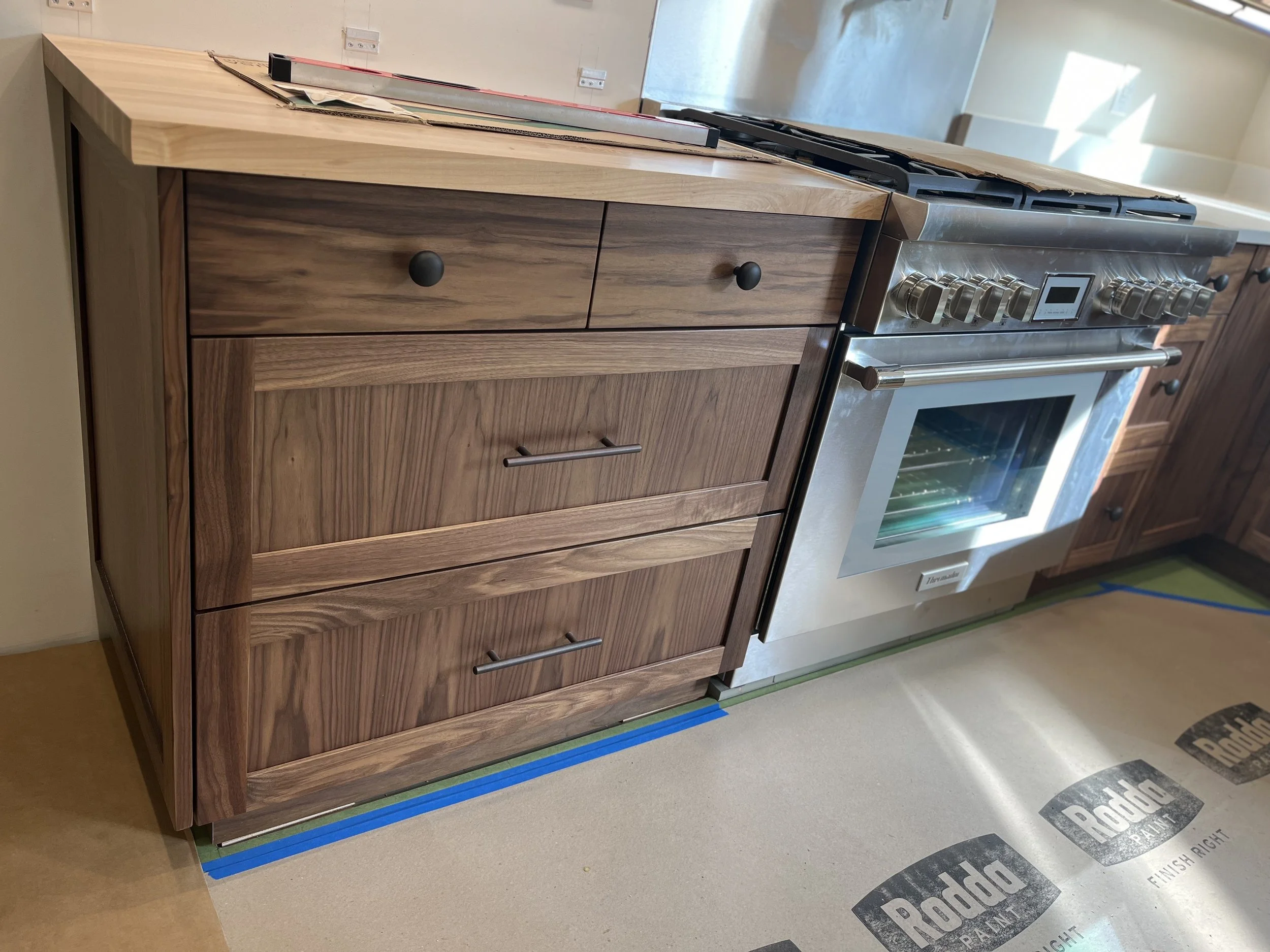Kitchen with wooden cabinets and a stainless steel oven and stove.