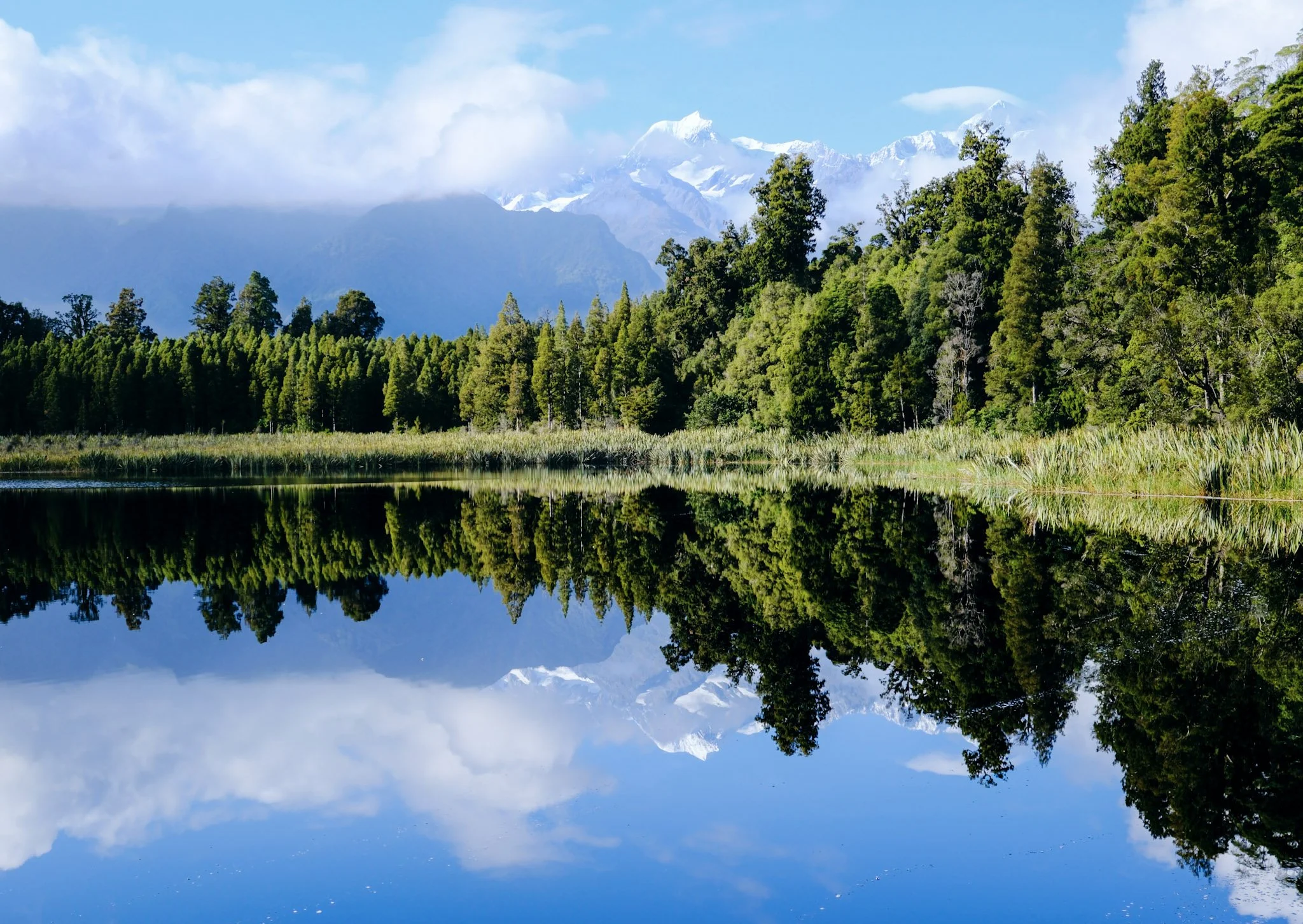 Mirror lake cradled by giants (Lake Matheson) 