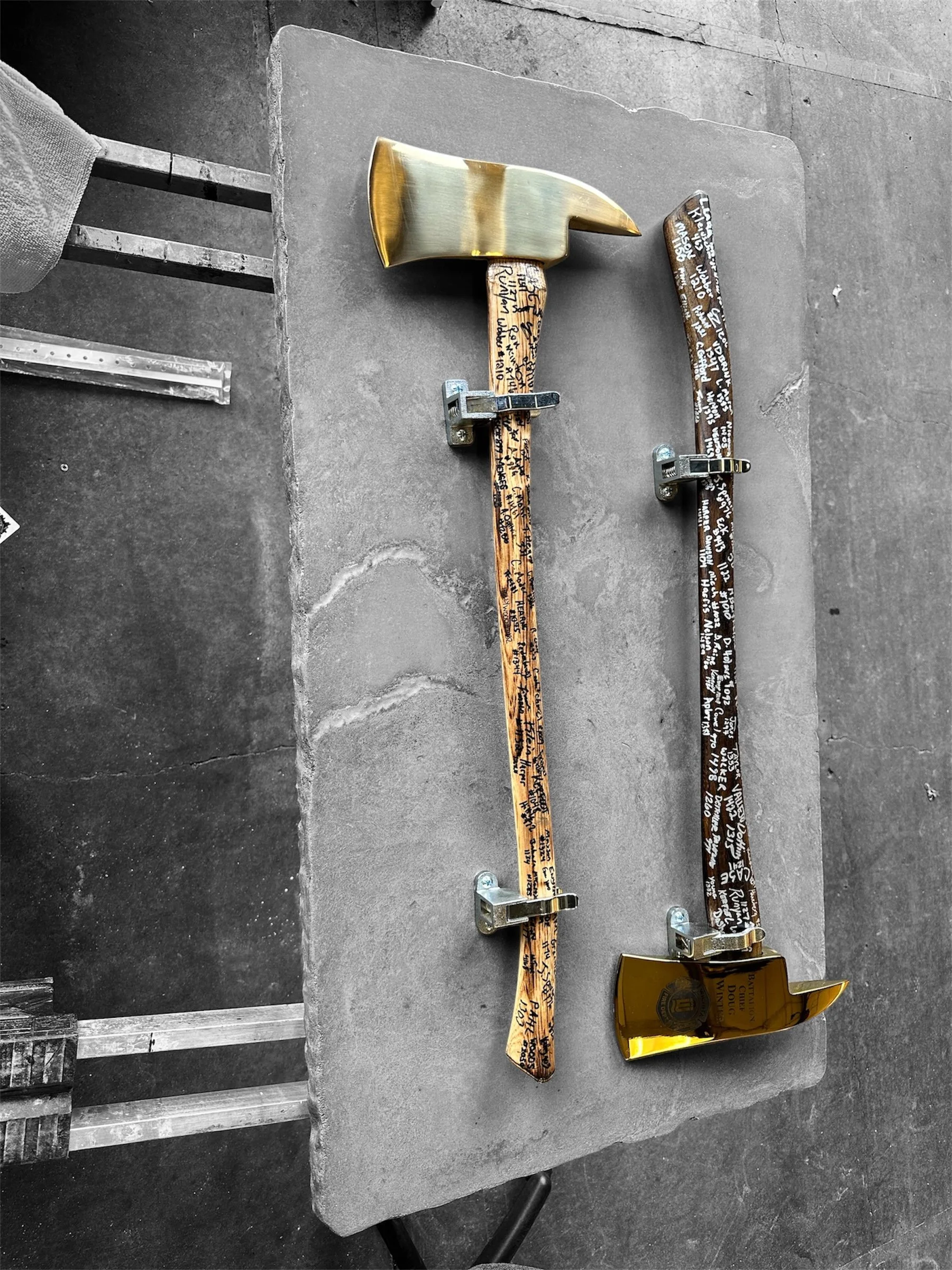 Custom handcrafted concrete display with engraved axes—Smoke & Stone Concrete Artistry, Wichita, KS