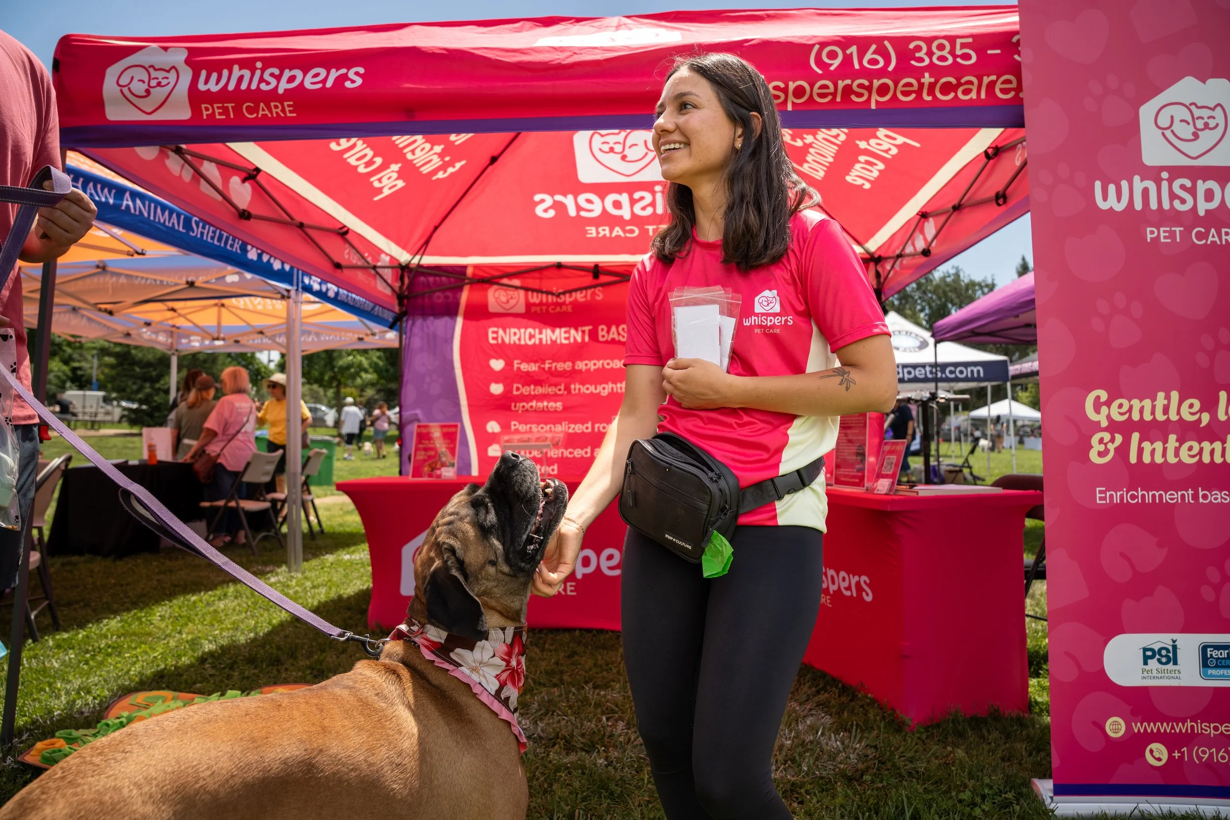 Woman petting dog at business event in Rancho Cordova, CA