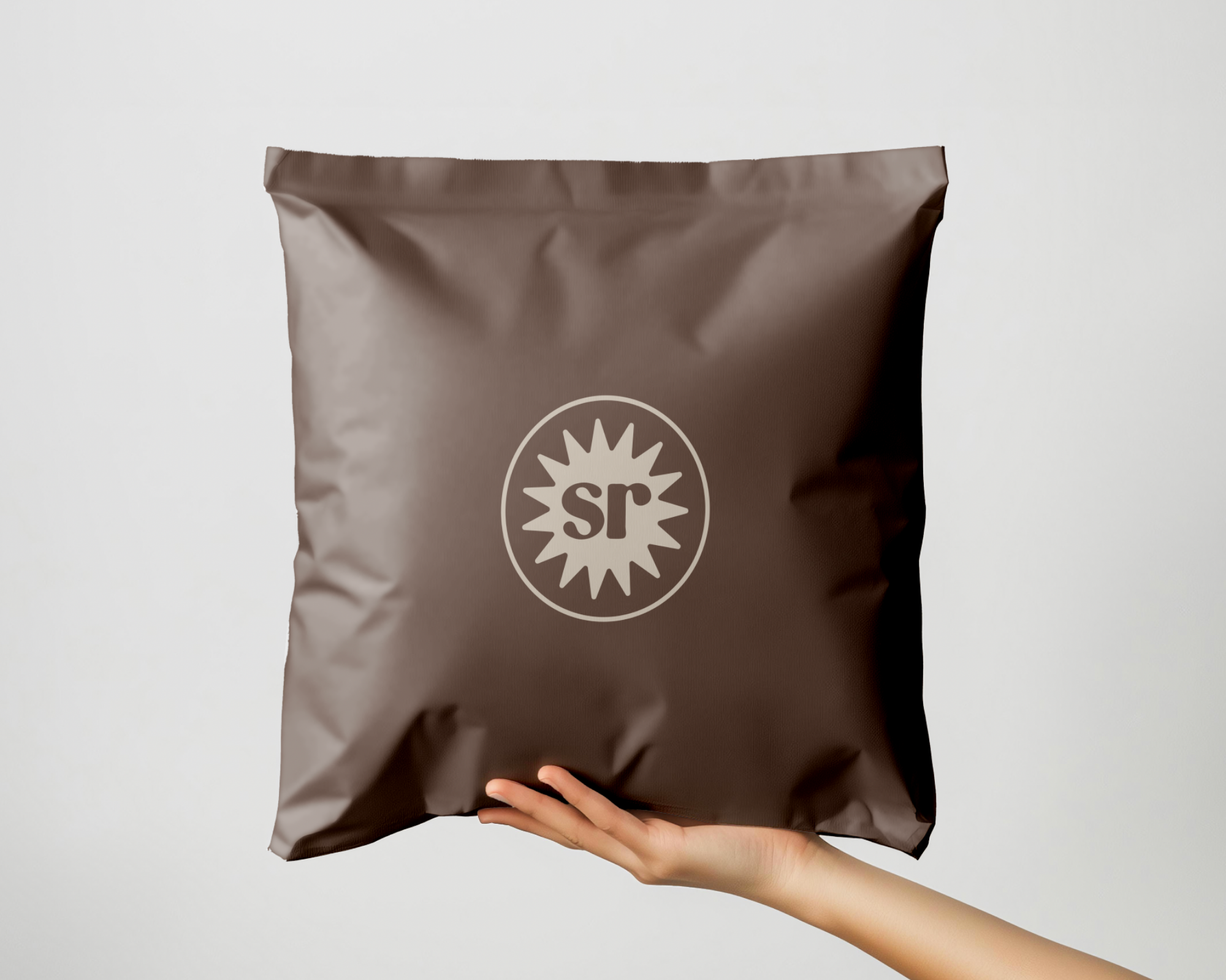 A paper bag with a croissant inside and purple text that says "Ben's Bakes" on it.