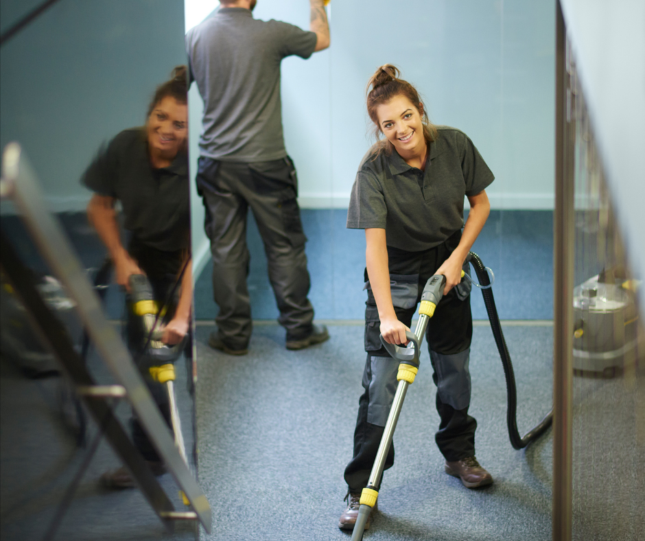 Professional commercial cleaning team vacuuming office floors during routine office cleaning services in New York and New Jersey.