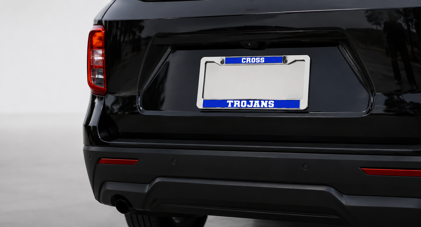 Cross High School Trojans license plate frame featuring royal blue and white school colors, designed for alumni, students, parents, and supporters.