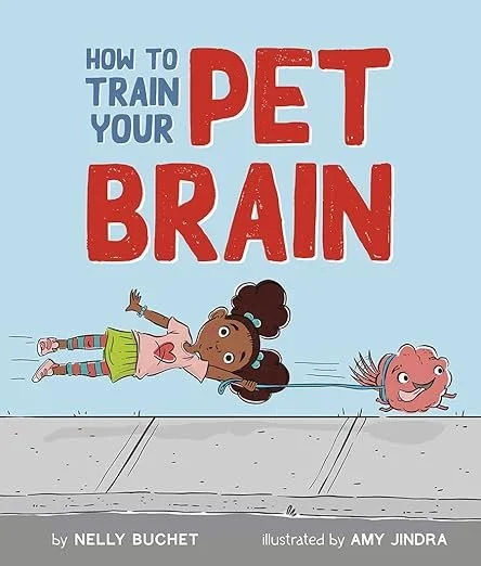 Cover of a children's book titled "How to Train Your Pet Brain" by Nelly Buchet, illustrated by Amy Jindra, featuring a young girl lying on her back with a brain-shaped pet dog next to her.