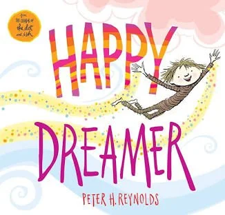 Colorful children's book cover titled 'Happy Dreamer' by Peter H. Reynolds, featuring a smiling girl with curly hair jumping with arms raised against a whimsical background with clouds and swirls.
