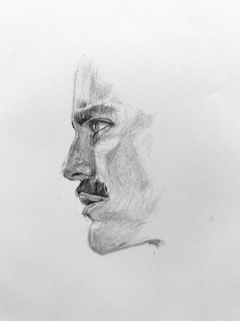 A pencil sketch of a man's face in profile, capturing detailed features like the eye, nose, mustache, and lips.