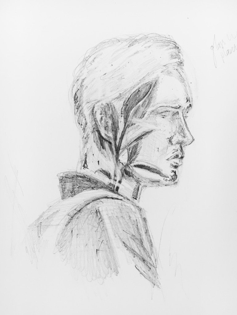 A pencil sketch of a person in profile view with short hair, wearing a jacket, looking to the right.