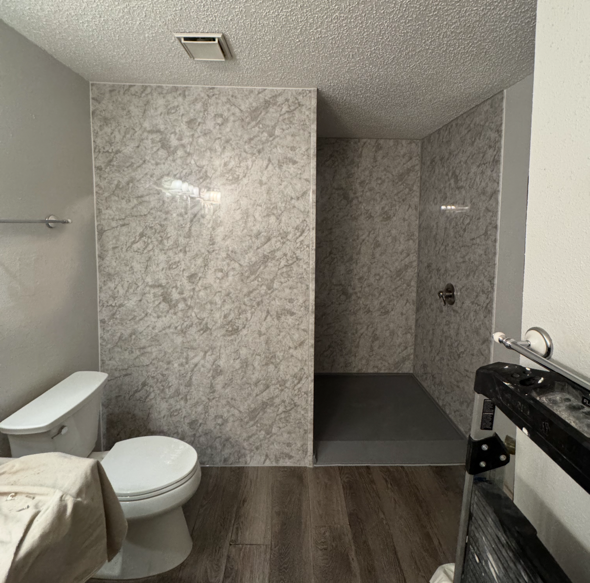 Acrylic shower with gray marble shower wall, wheelchair accessible entry, full walk-in with valve as you walk in.