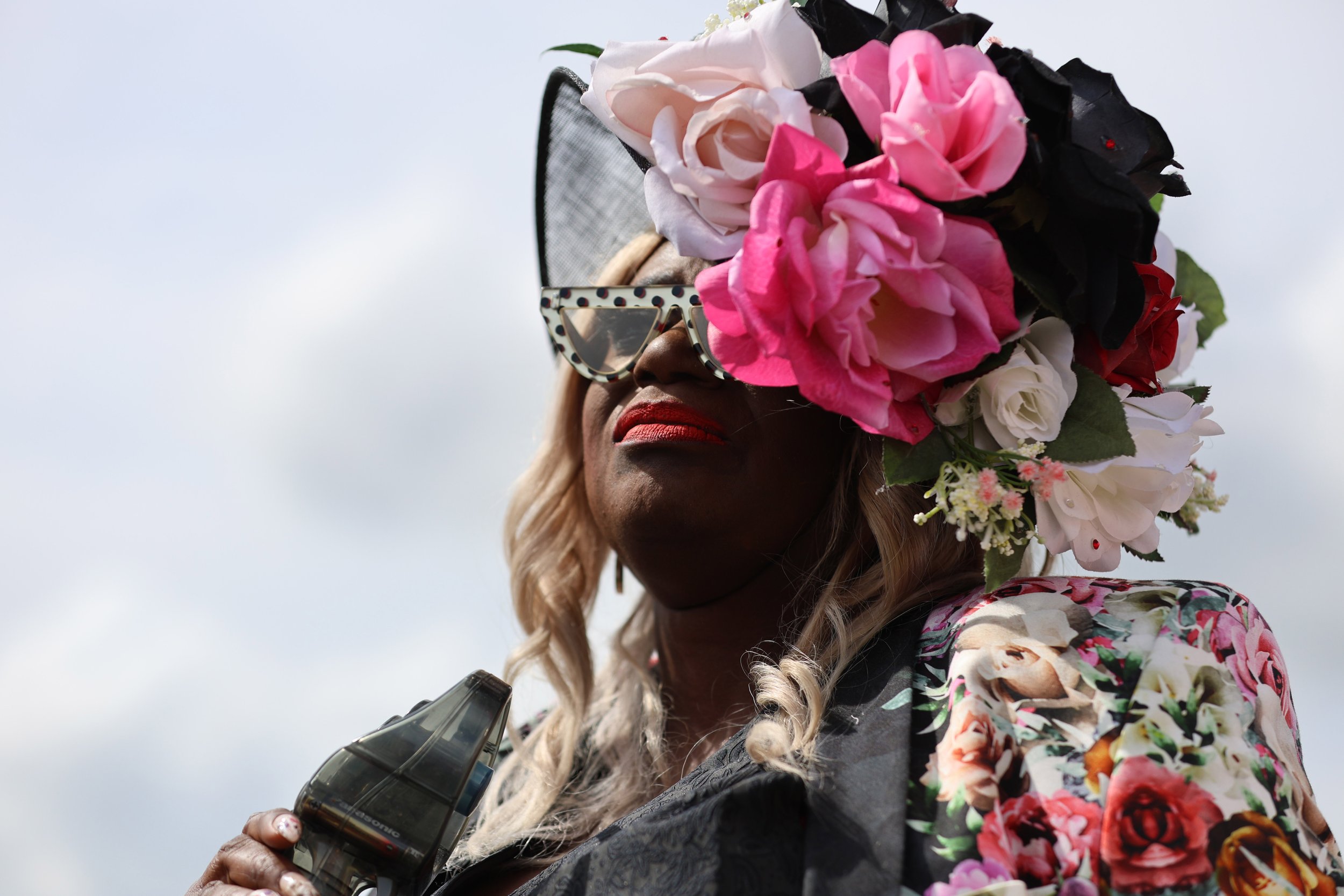 Wanda Faye Johnson, 60, of Charlotte, NC, fans herself as she attends her second time to the Carolina Cup. “I love to look at the outfits, especially the men,” Johnson said.