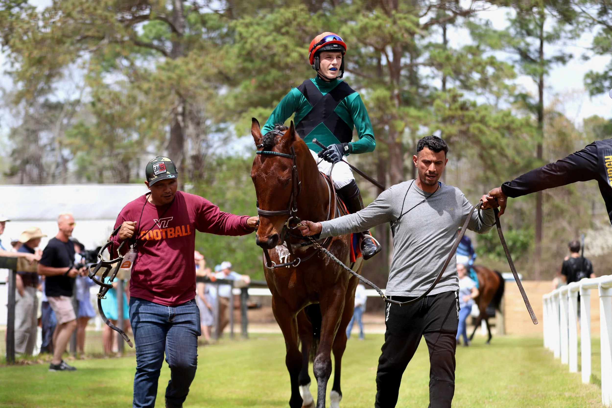 Jockey Freddie Proctor is riding Beyond Reproach as he prepares to enter the field for the first race during the Carolina Cup with the help of his team.